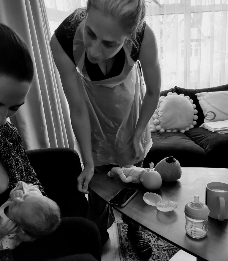 Eszter lactation consultant supporting a breastfeeding mother during a consultation